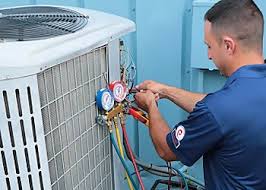 Technician connecting pressure gauges to an outdoor air conditioning condenser